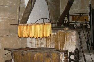 Yellow tallow candles hanging above trough, as in the 1800s